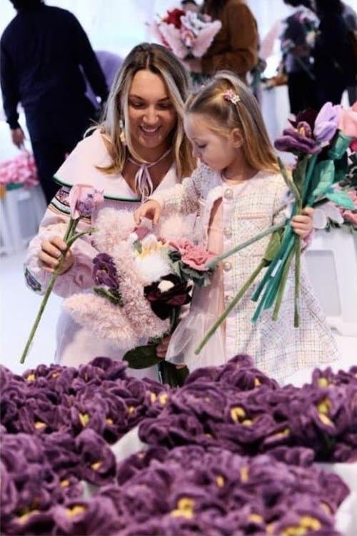 A mother and daughter holding plush flowers at Cj Hendry’s Flower Market