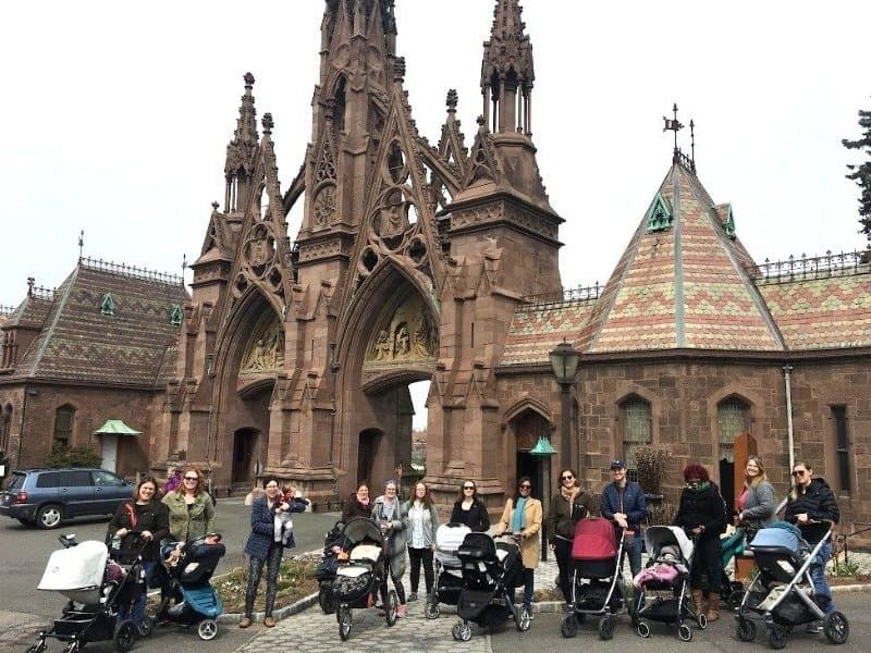 Parents pushing strollers along a path at Green-Wood Cemetery