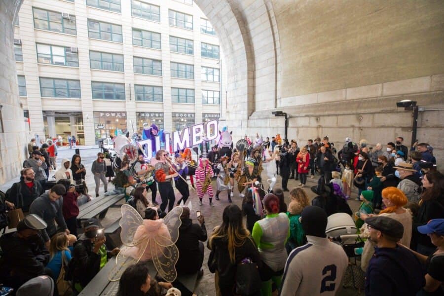 A crowd in costume gathers under the Archway for the Dumboween party