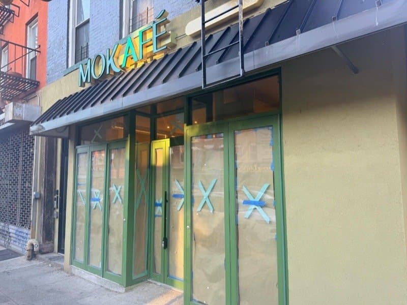 Mokafé’s new coffee shop at the corner of Pacific and Smith Streets, sign up and windows papered over
