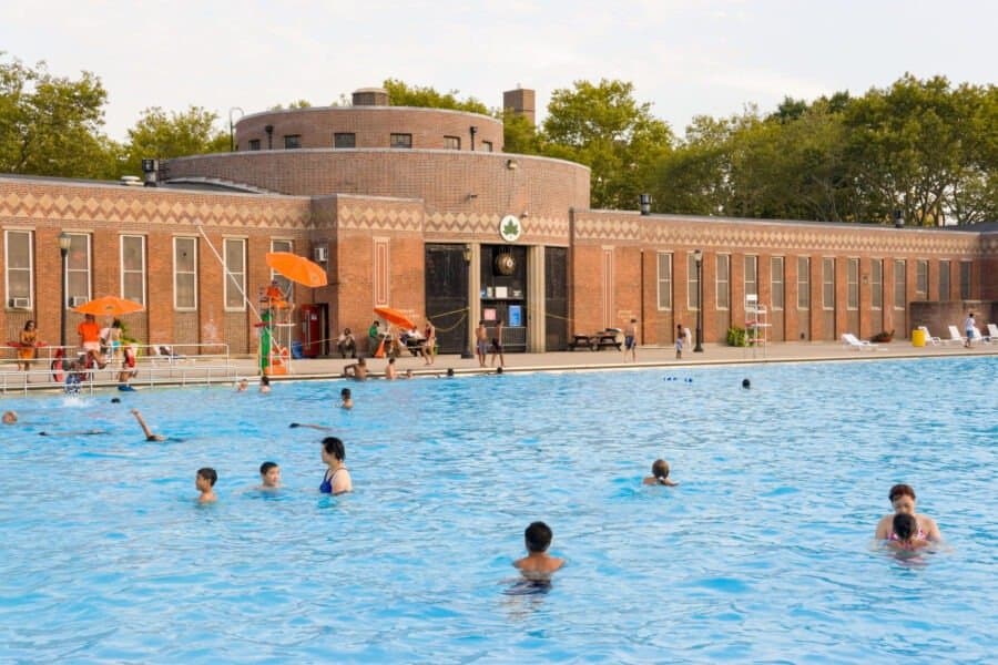 Swimmers in the outdoor pool at Sunset Park on a sunny day